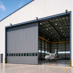 Aircraft Hangar Door with large industrial sliding door and private jet inside